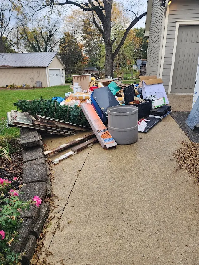 Dumpster being loaded with debris for Estate Cleanout Dumpster Rental in New Richmond